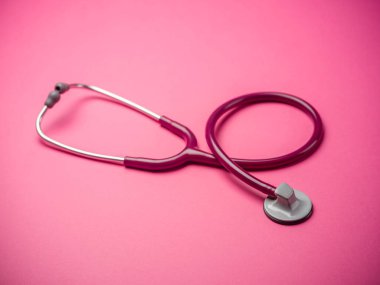 A stethoscope over pink