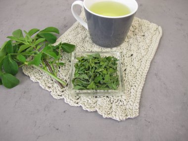 Alfalfa leaf tea, herbal tea from dried lucern leaves clipart