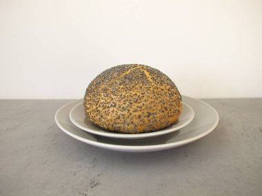 A poppy seed roll on a plate clipart