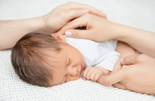 父母的手保护婴儿抱着妈妈的手指 儿童保护 新生儿保健 家庭中的儿童抚养和关爱 睡在白毛毯上的婴儿 — 图库照片