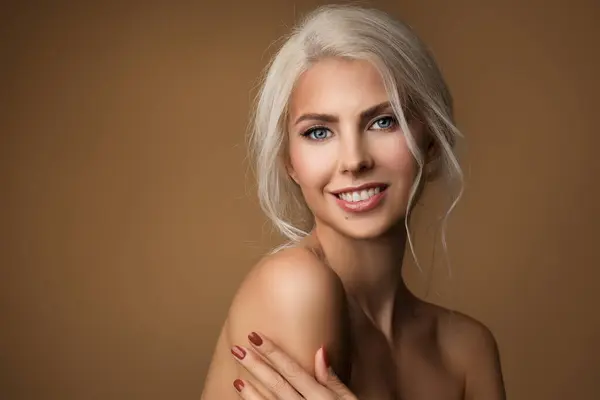 Beauty Woman Face cheerful smiling. Beautiful Blond Model with smooth Skin nature Makeup over brown. Female Anti age Facial and Body health Care Treatment