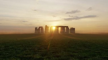 Sunset at the Stonehenge, United Kingdom. Digital render.Prehistoric megalithic monument Stonehenge. Beautiful panorama of Stonehenge early morning. Sunrise glow seen on the historical landmark.