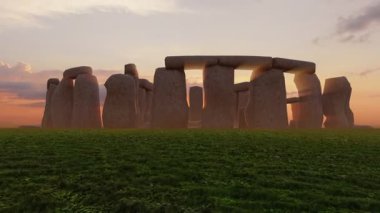 Sunset at the Stonehenge, United Kingdom. Breathtaking sunset view of Stonehenge with sunlight streaming through the ancient stones.