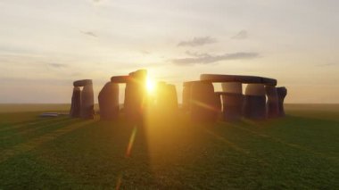 Sunset at the Stonehenge, United Kingdom. Breathtaking sunset view of Stonehenge with sunlight streaming through the ancient stones.