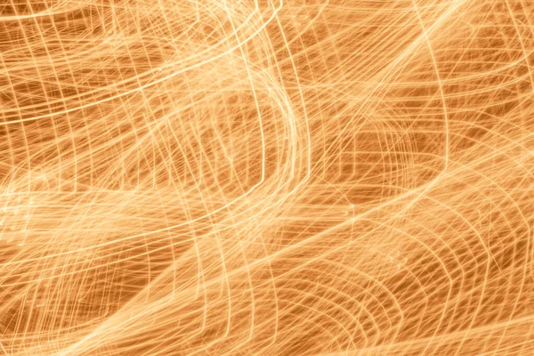 abstract golden background: tangled tracks of lights