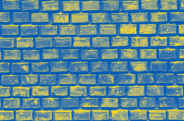 brick wall colored in colors of Ukrainian flag background