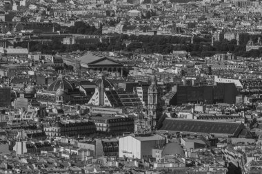 Paris 'in yaz günündeki çatılarının siyah beyaz fotoğrafı.