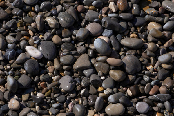 view on wet pebblestones on beach in Nice
