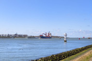 Landscape Dutch river the Maas with cargo ships clipart