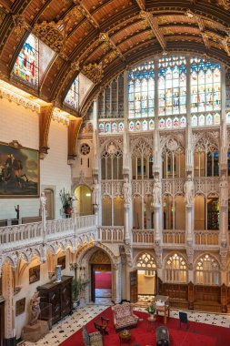 Lutter Castle's grand hall features ornate details and vibrant stained glass.