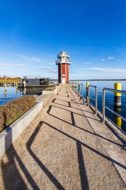 Lighthouse and harbor on lake Plauer See in the town of Plau am See, Germany. clipart