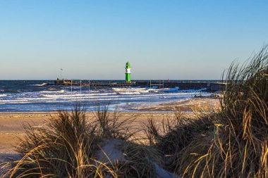 Pier with tower on shore of the Baltic Sea in Warnemuende, Germany. clipart