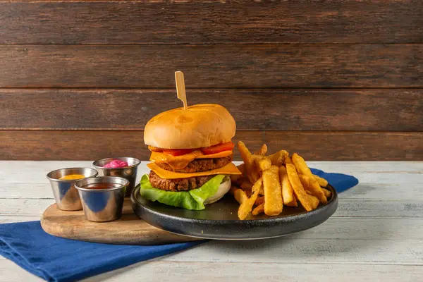 Taze marul, domates ve erimiş peynirle dolu ağız sulandıran bir hamburger. Kızarmış patatesler bu cazip yemeğe eşlik eder. Sıradan bir yemek için birebirdir..