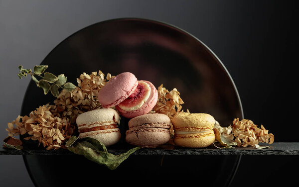 Delicious sweet colorful macaroons with dried flowers.