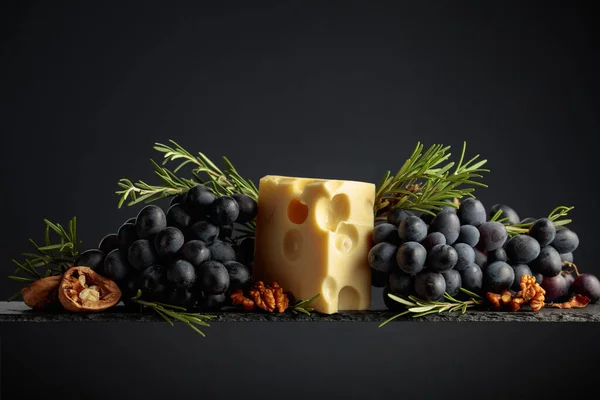 Maasdam Cheese Walnuts Blue Grapes Rosemary Black Background — Stock Photo, Image