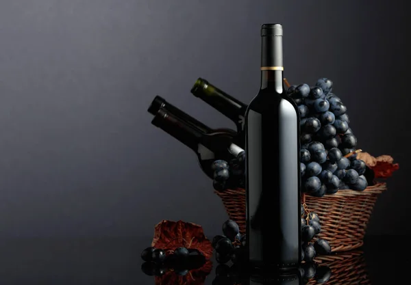 Red Wine Blue Grapes Black Reflective Background Focus Bottle — стоковое фото