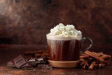 Krem şantili sıcak çikolata. Kahverengi bir masada malzemeli sıcak çikolata..