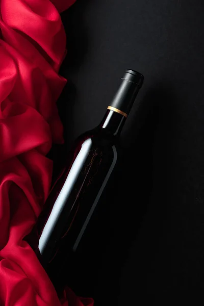 Bottle Red Wine Red Satin Black Background Top View —  Fotos de Stock
