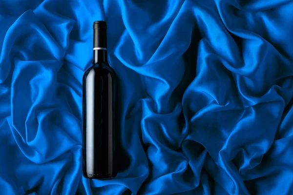 Bottle Red Wine Blue Satin Background Top View — Stock fotografie
