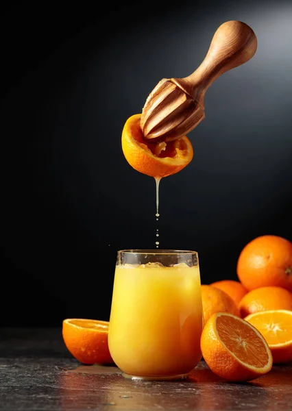 オレンジジュースは新鮮な果物から絞り出されます ジュースは氷でガラスに注がれます 自然有機食品の概念 — ストック写真