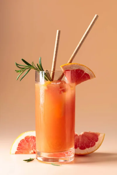 stock image Summer cocktail with grapefruit, rosemary, and ice in a frozen glass.