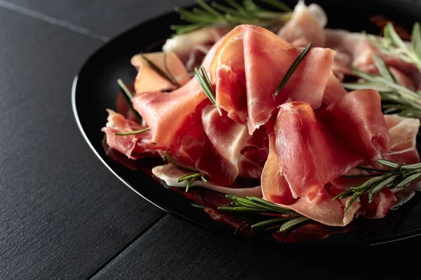 Italian Prosciutto Spanish Jamon Rosemary Black Plate — Stock fotografie