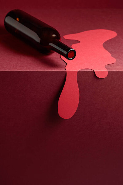 Bottle of red wine on a red background. Concept of the theme of red wine. Copy space.