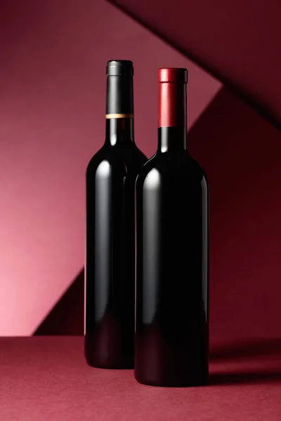 Bottles Red Wine Red Background Copy Space — Stock Photo, Image