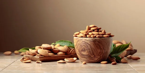 Almond Nuts Wooden Dishes Ceramic Table Brown Background Copy Space — Stock Photo, Image