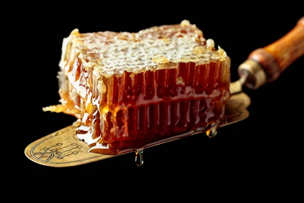 Close Honeycombs Antique Brass Spatula Isolated Black Background — Stock Photo, Image
