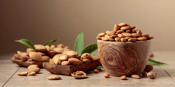 Almond Nuts Wooden Dishes Ceramic Table Brown Background Copy Space — Stock Photo, Image