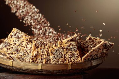 Sunflower seeds and flax seeds are poured on crispy crackers with sunflower seeds and flax seeds. Healthy organic food.