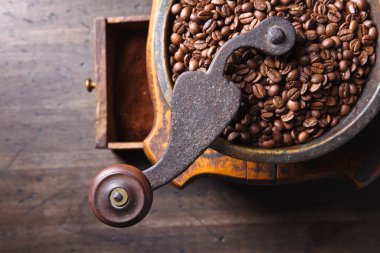 Eski kahve öğütücüsü ve kavrulmuş kahve çekirdekleri.