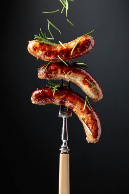 Biberiyeli ızgara Bavyera sosisi. Biberiye serpilmiş çatallı sosisler..