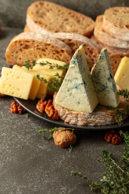 Mutfak masasında peynir, ekmek, ceviz ve kekik. Boşluğu kopyala.