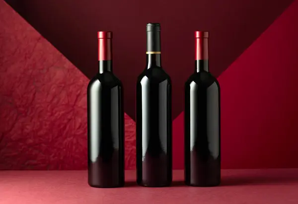 Bottles Red Wine Red Background Copy Space Your Text — Stock Photo, Image