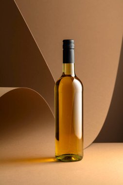 Bottle of white wine on a beige background. Copy space.