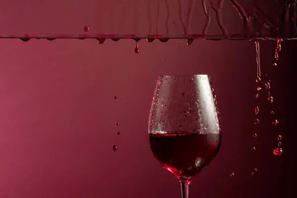 Red Wine Flows Glass Dark Red Background Copy Space — Stock Photo, Image