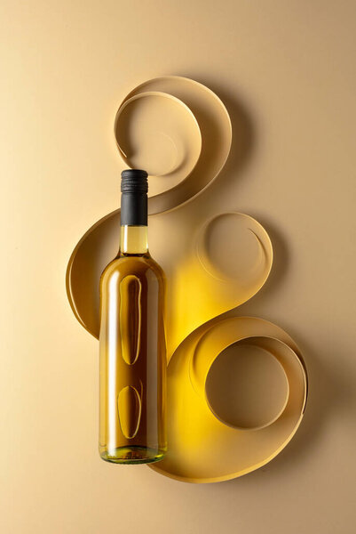 Bottle of white wine on a beige background. Top view. Copy space.