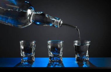 Alkolik votka kadehleri ya da küçük bardaklarda sert içkiler. Barmen sert ruhu bardaklara doldurur, servis ve içecekler hakkında konsept yapar. Boşluğu kopyala.