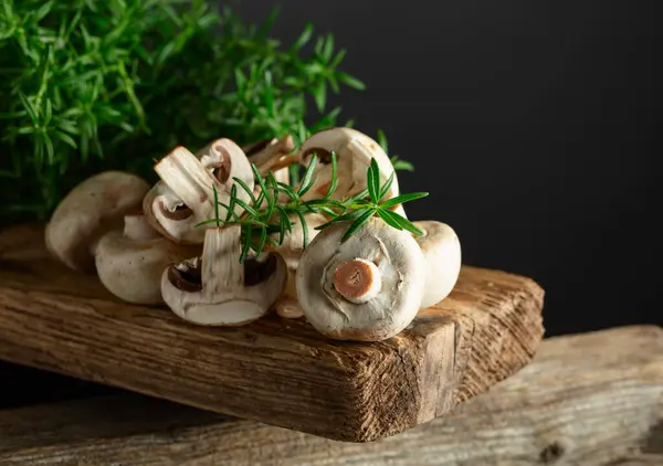 White Champignons Rosemary Old Wooden Board Stock Image