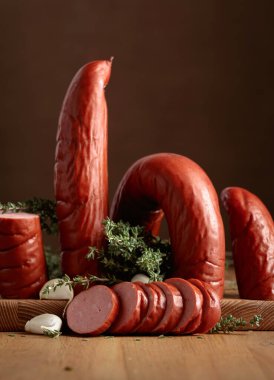 Tahta bir masada kekik ve sarımsaklı füme sosis. Boşluğu kopyala.