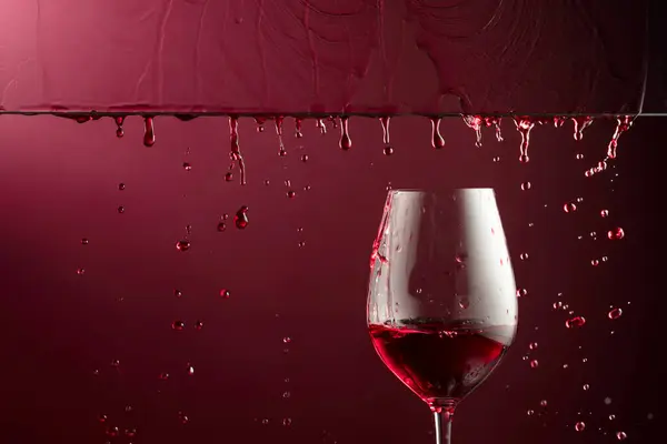 Red Wine Flows Glass Dark Red Background Copy Space — Stock Photo, Image