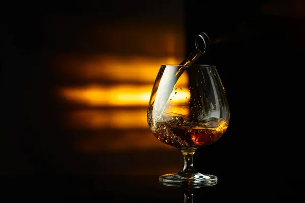 Pouring Brandy Bottle Snifter Black Reflective Background Copy Space — Stock Photo, Image