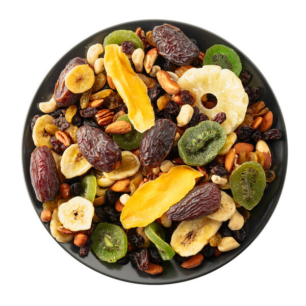 Dried tropical fruits with various nuts and raisins isolated on a white background.