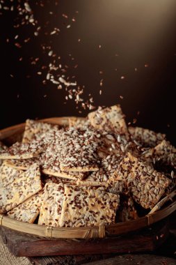 Sunflower seeds and flax seeds are poured on crispy crackers with sunflower seeds and flax seeds. Healthy organic food.