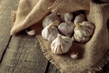 Garlic bulbs on an old wooden table.