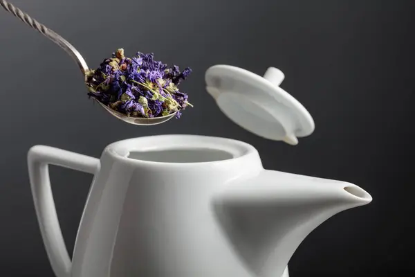 stock image Dried mallow flowers are poured into the teapot. Selective focus.