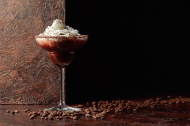 Kahverengi arka planda kremalı kahve ve çikolata kokteyli. Boşluğu kopyala.