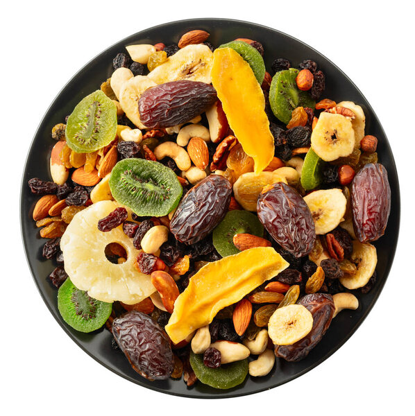 Dried tropical fruits with various nuts and raisins isolated on a white background.